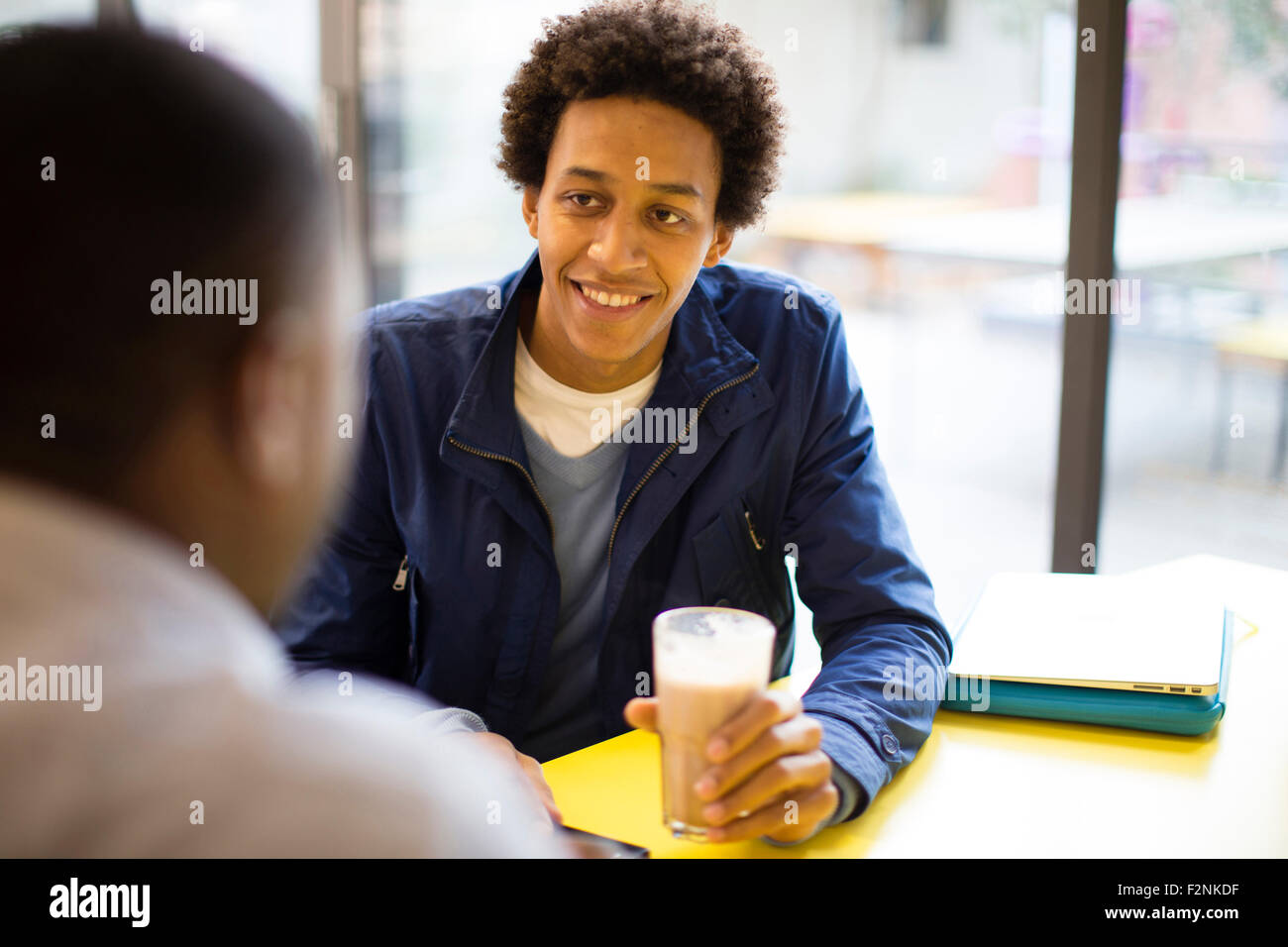Men drinking coffee in cafe Stock Photo