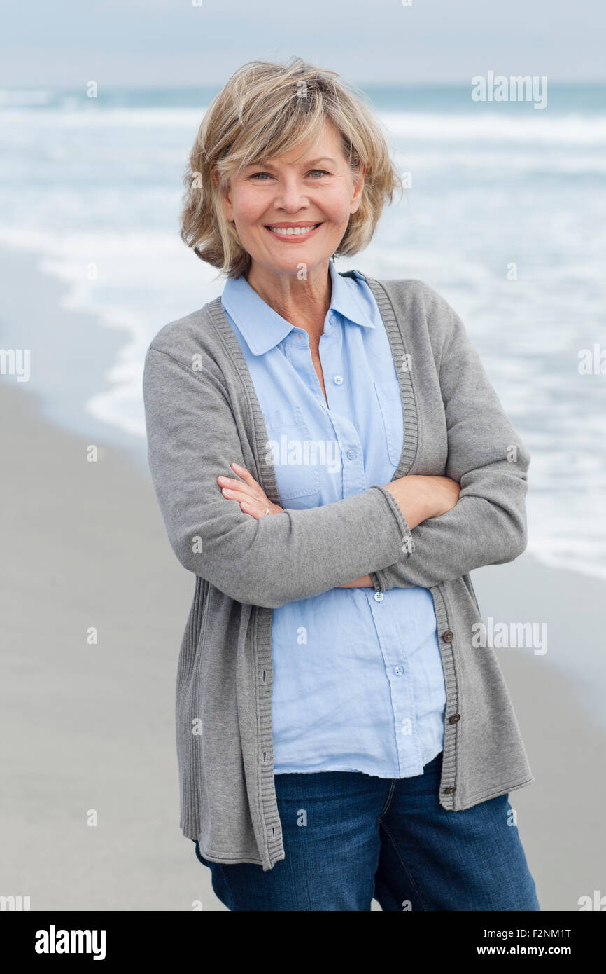 Woman standing crossing arms hi-res stock photography and images - Alamy