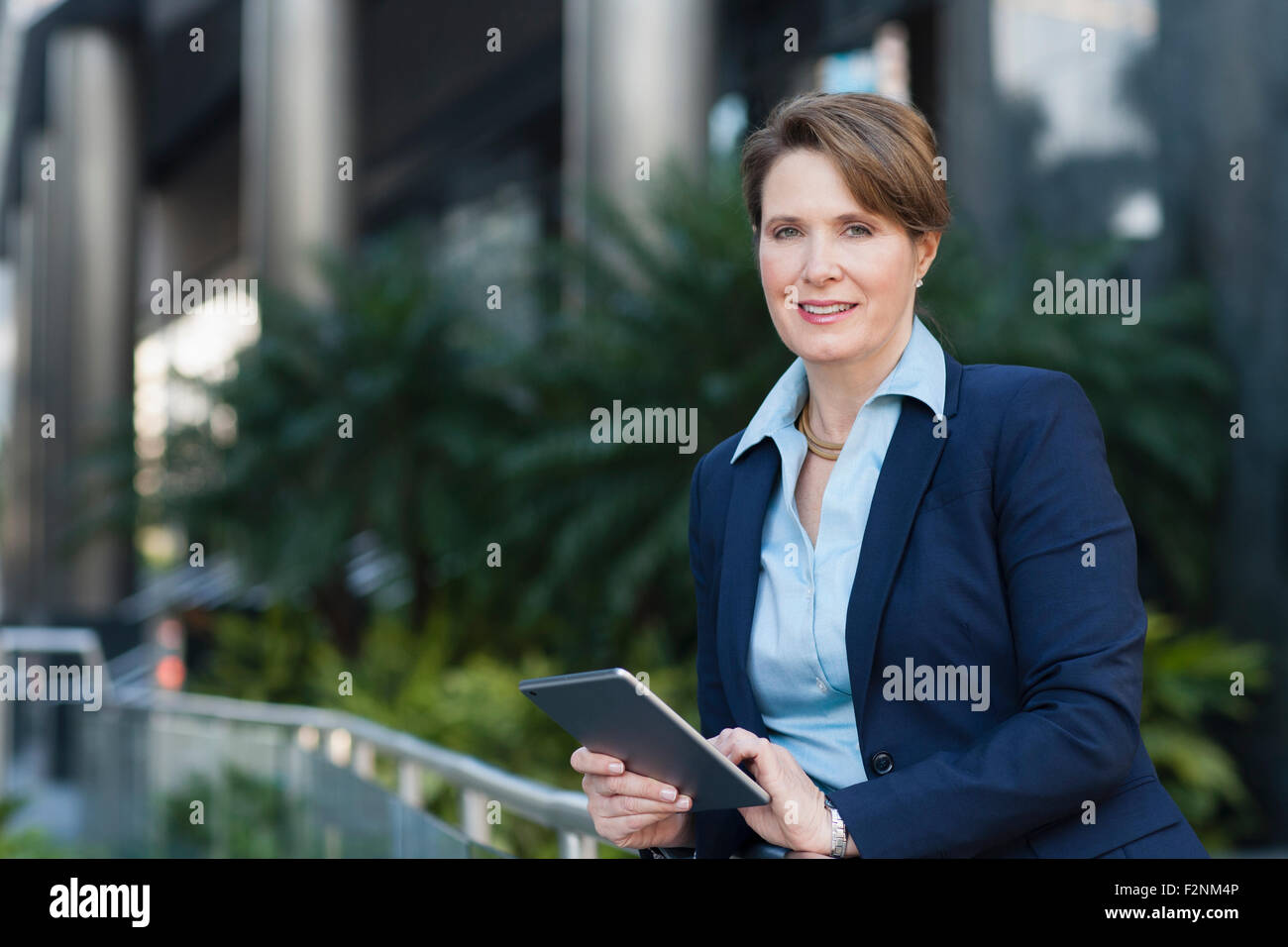 Caucasian businesswoman using digital tablet outdoors Stock Photo