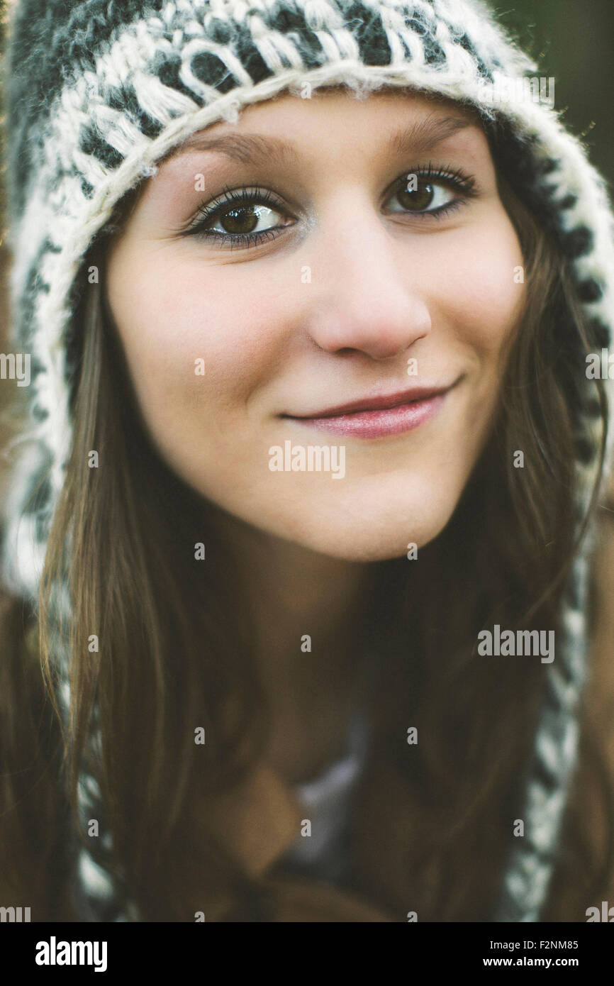 Close up of smiling Caucasian woman wearing knitted hat Stock Photo