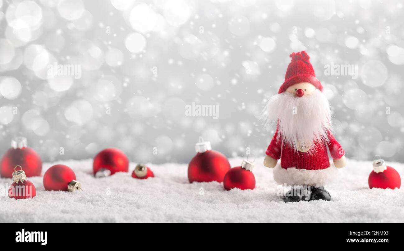 Santa Claus and Christmas balls on snow. Stock Photo
