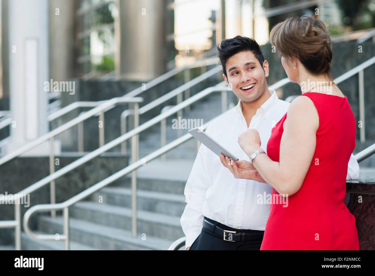 Business people using digital tablet near staircase Stock Photo