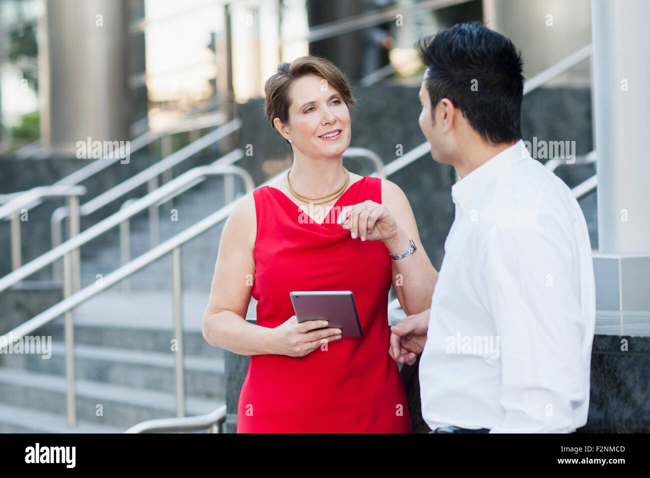 Business people using digital tablet near staircase Stock Photo