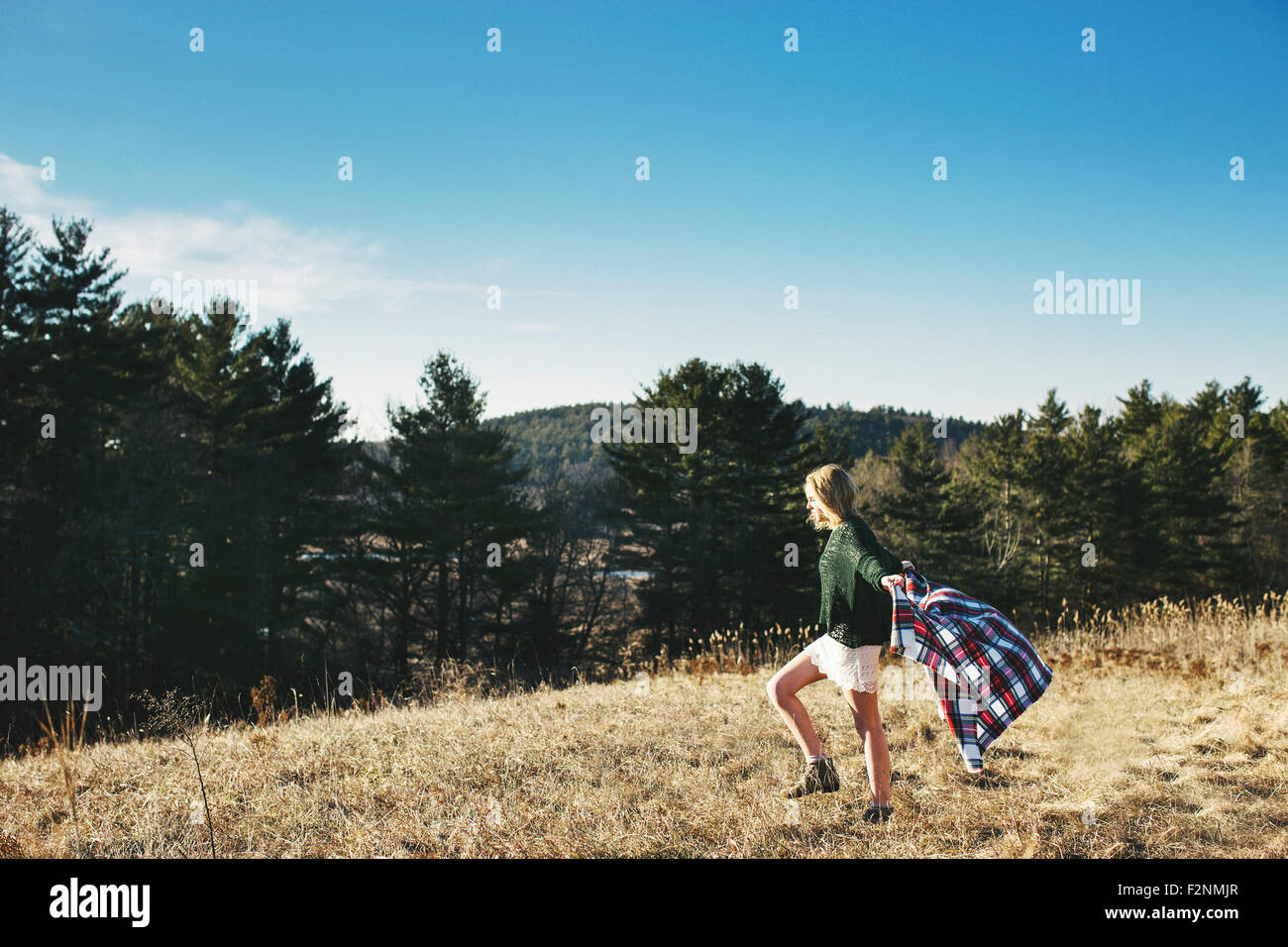 Caucasian woman playing with scarf on rural hilltop Stock Photo
