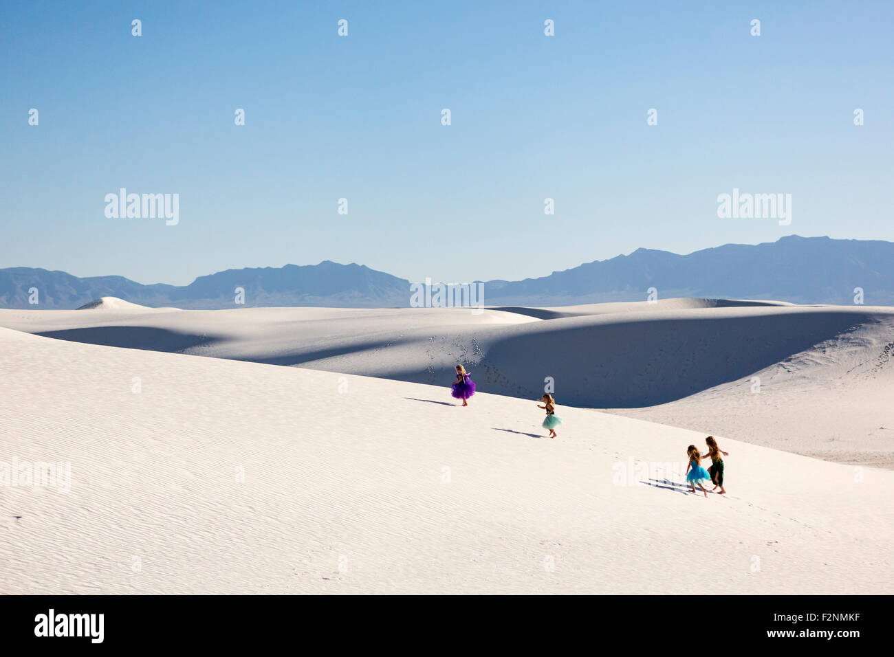 Girls walking on desert sand dunes Stock Photo