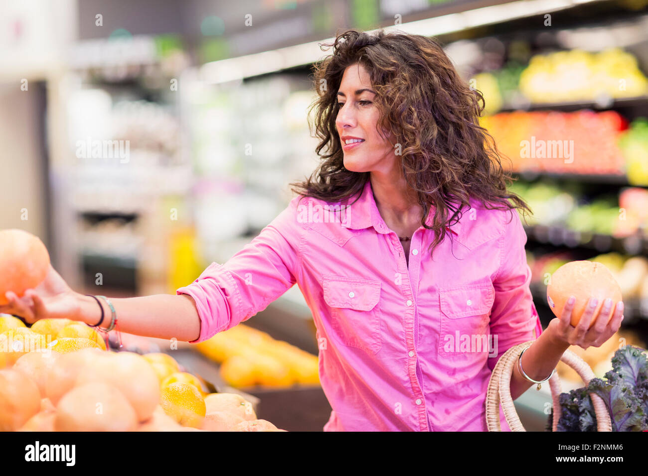 Hispanic woman shopping at grocery store Stock Photo