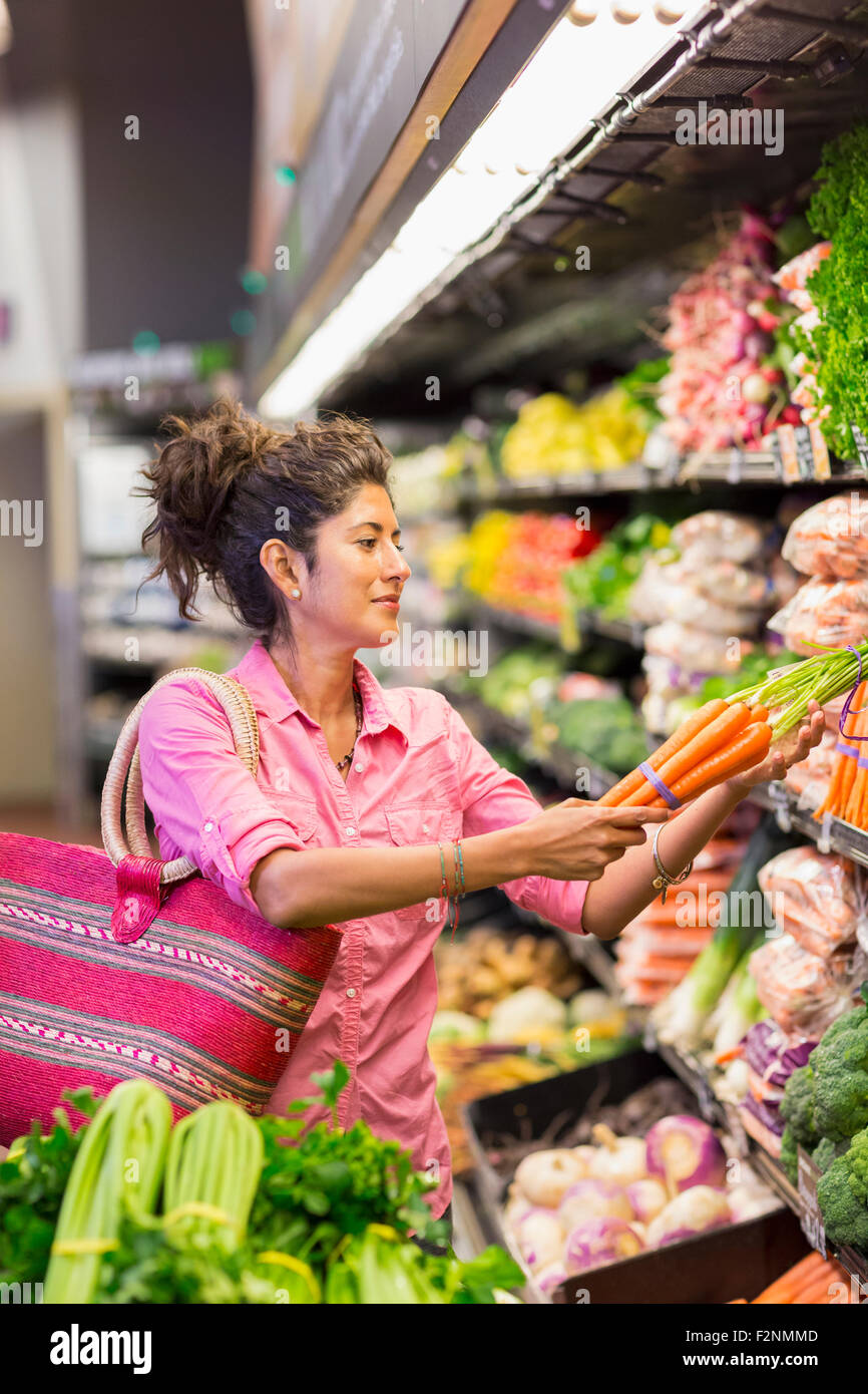 Hispanic woman shopping at grocery store Stock Photo
