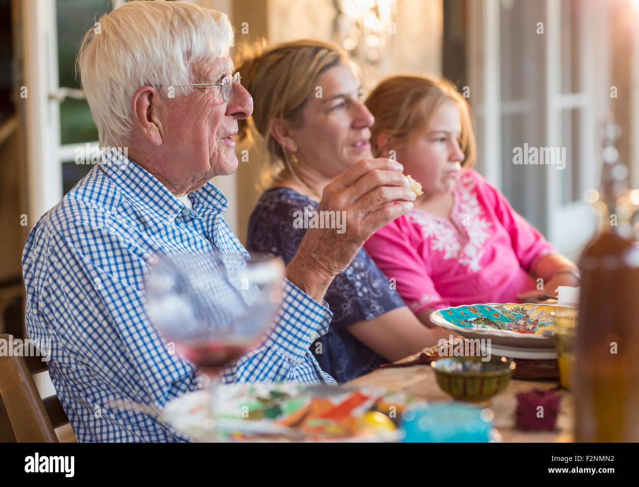 Caucasian family eating at table outdoors Stock Photo