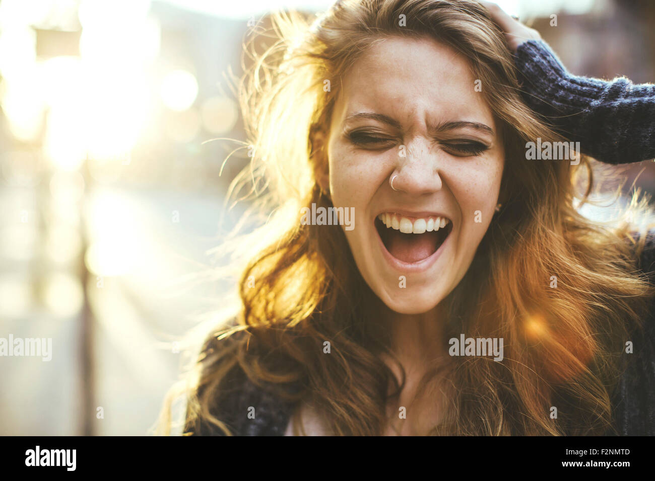 Caucasian woman shouting outdoors Stock Photo