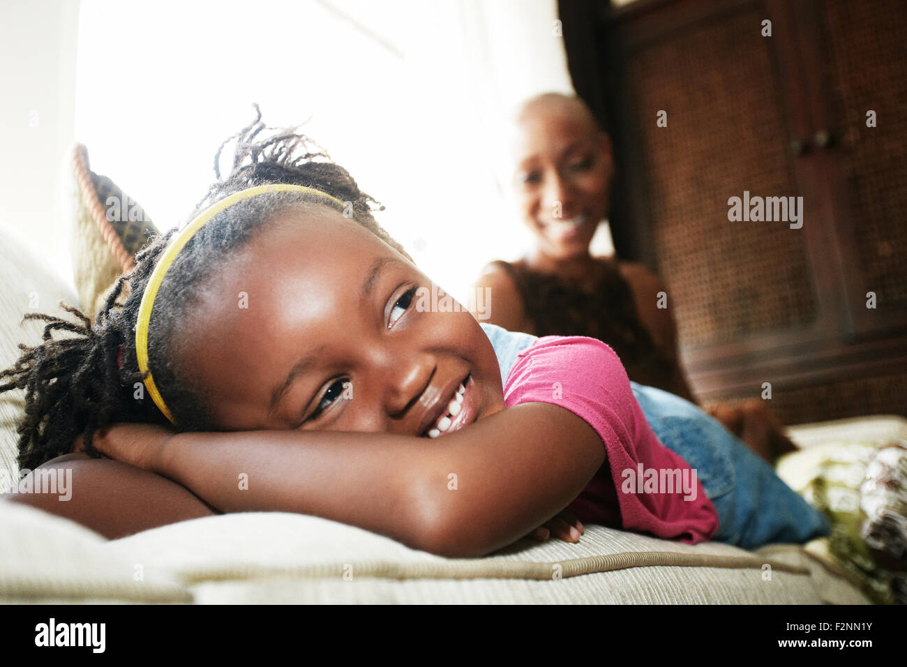 Black girl laying on sofa Stock Photo