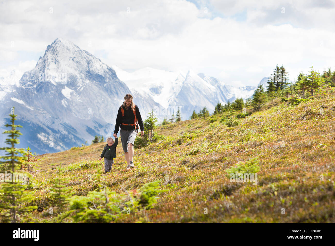 Caucasian mother and son hiking on remote hillside Stock Photo