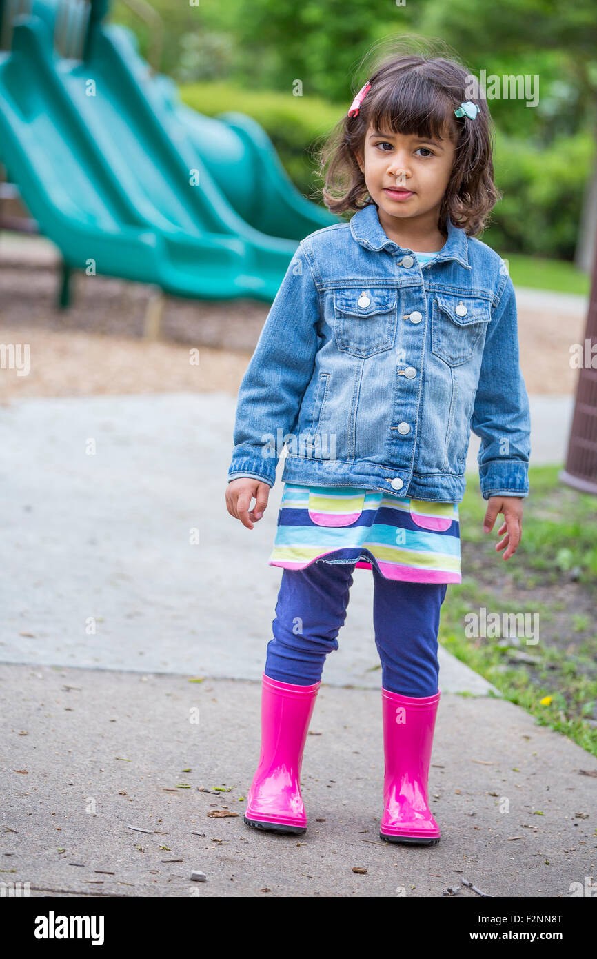 Girl wearing rain boots at playground Stock Photo Alamy