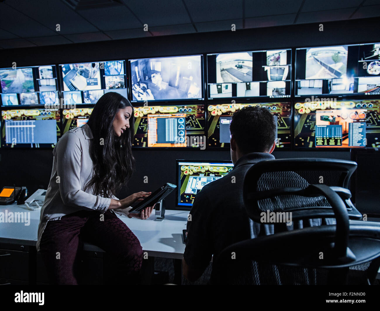 Security guards watching monitors in control room Stock Photo