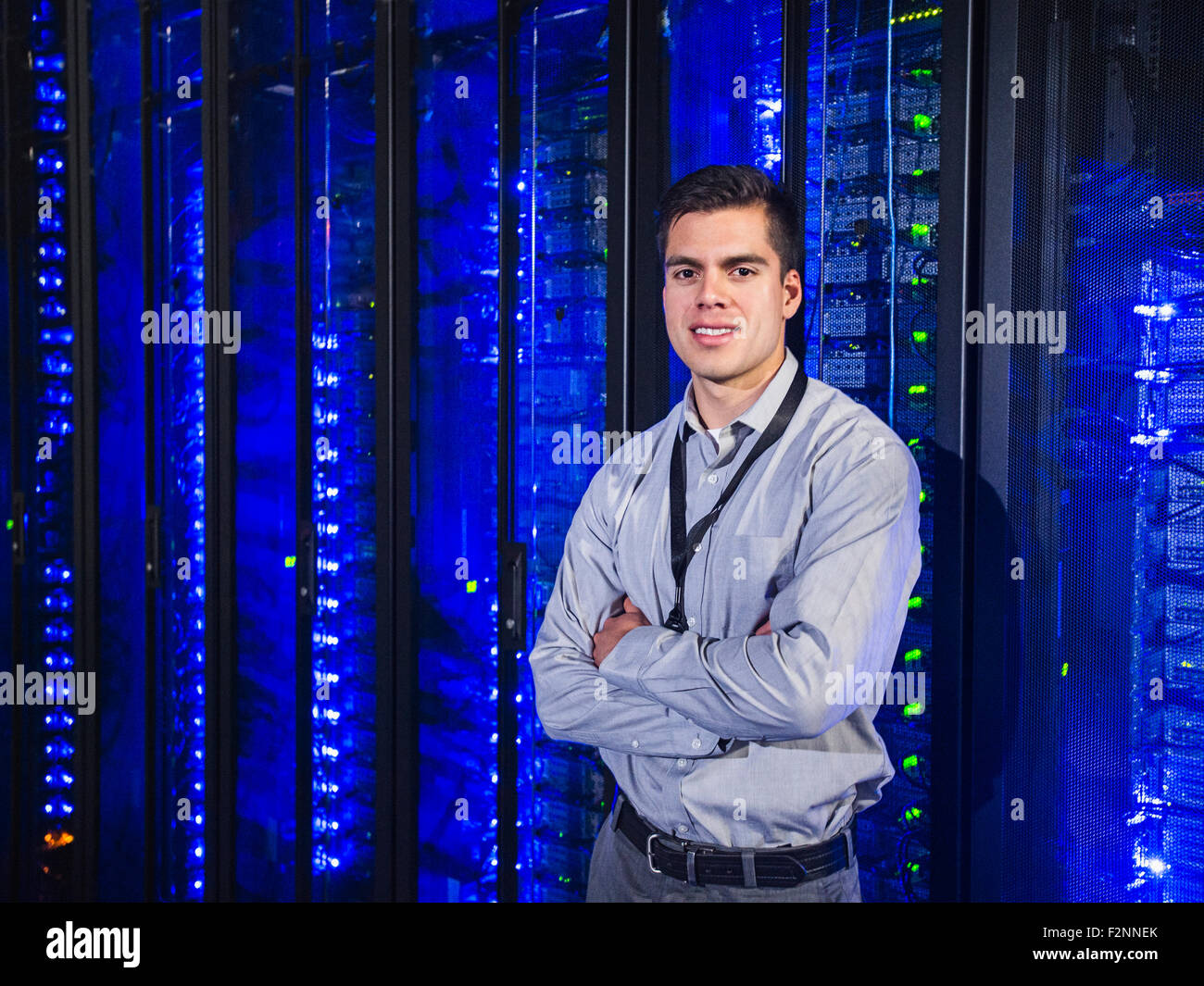 Hispanic technician smiling in server room Stock Photo