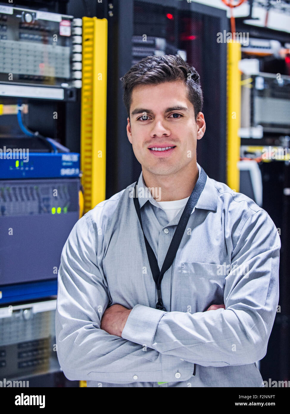 Hispanic technician smiling in server room Stock Photo