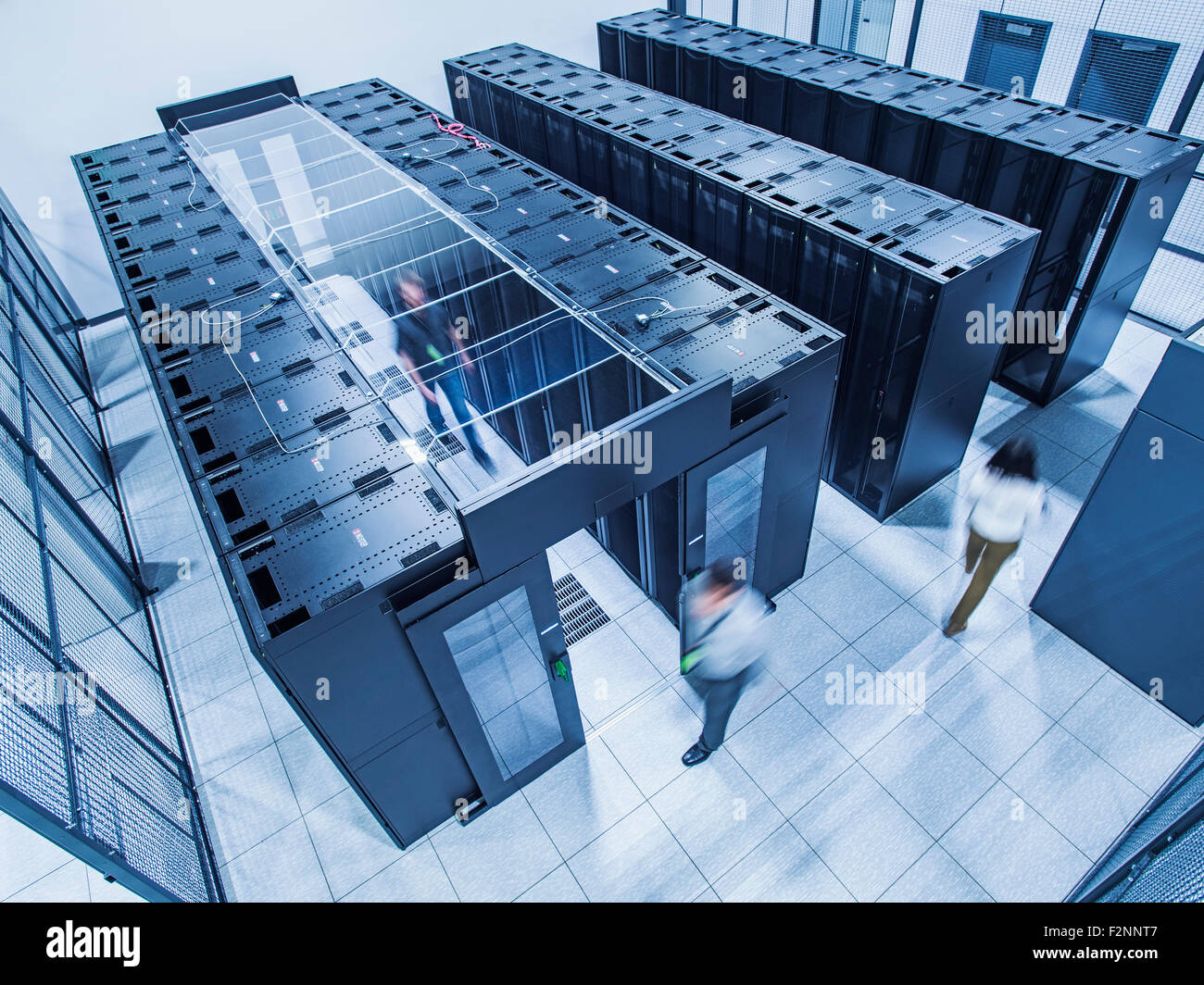 High angle view of technicians walking in server room Stock Photo