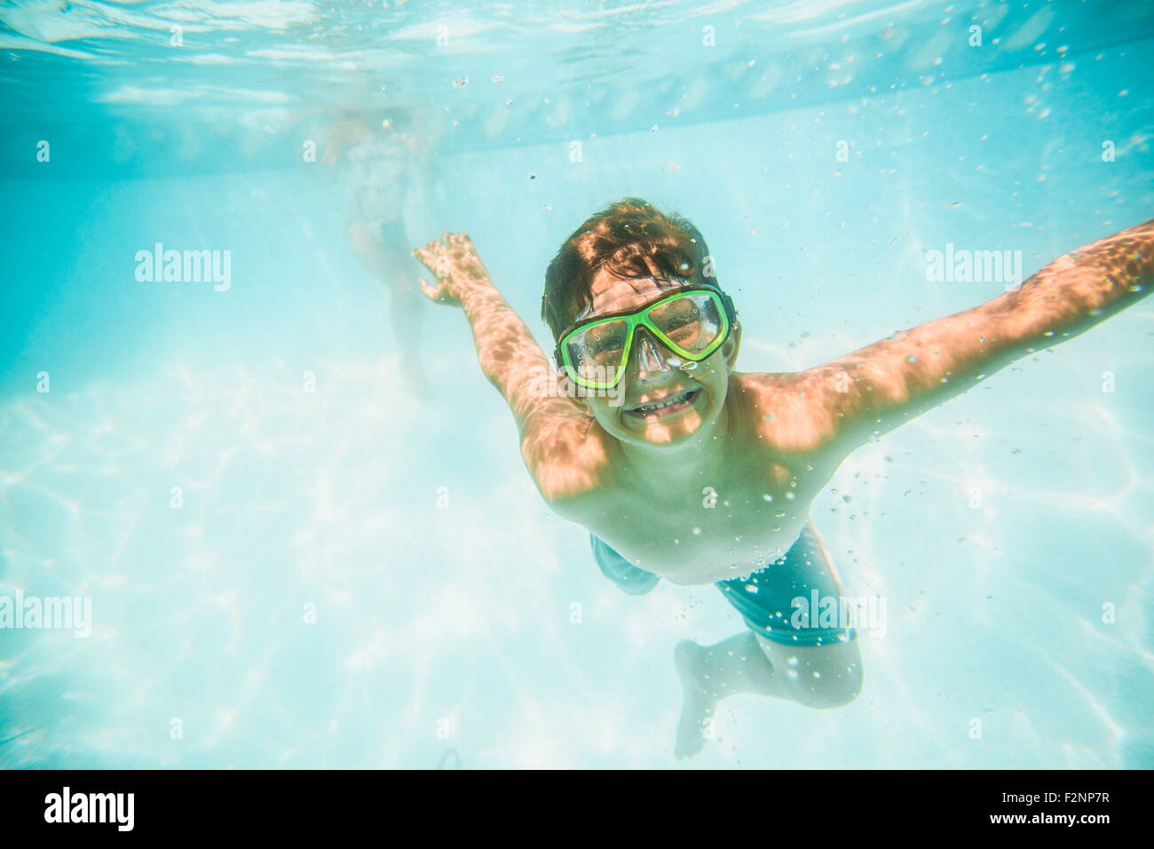 Underwater breath holding. Boys swimming under water. Boys underwater. Boys swimming under water in pool. Boys swimming under water.