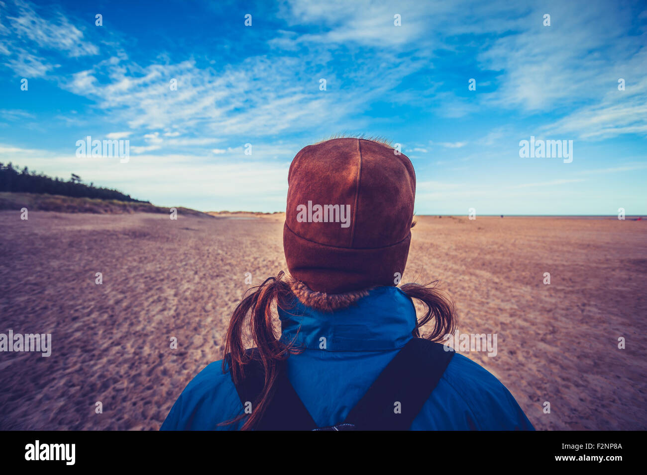 Young woman walking on beach in winter Stock Photo