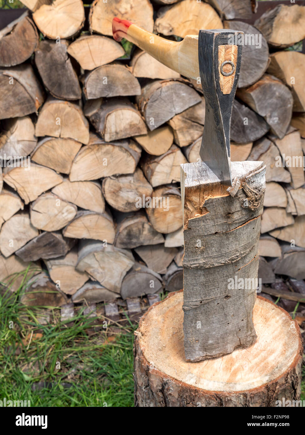 Chopping block with axe driven into log Stock Photo