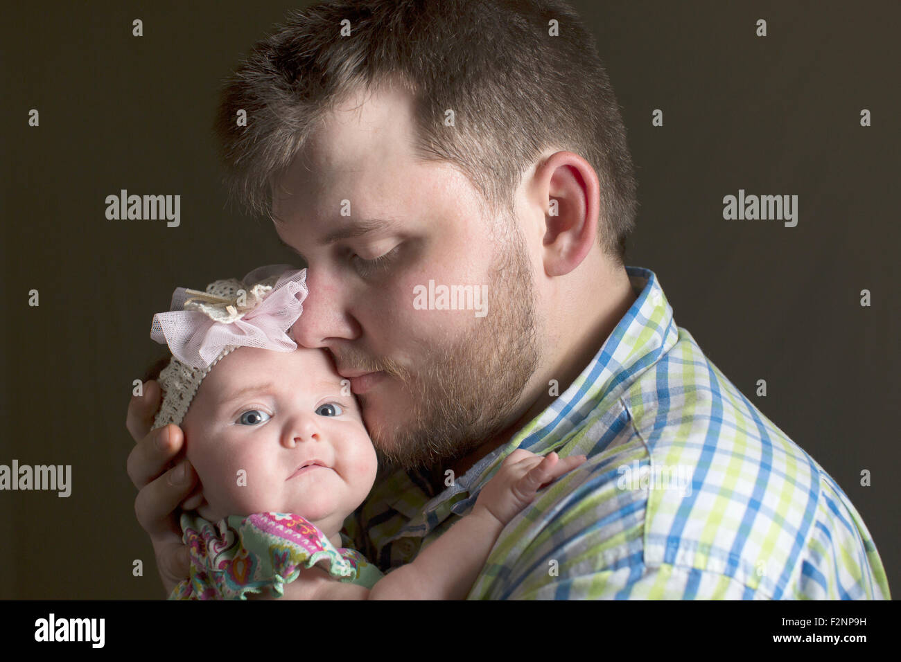 Caucasian father holding daughter Stock Photo