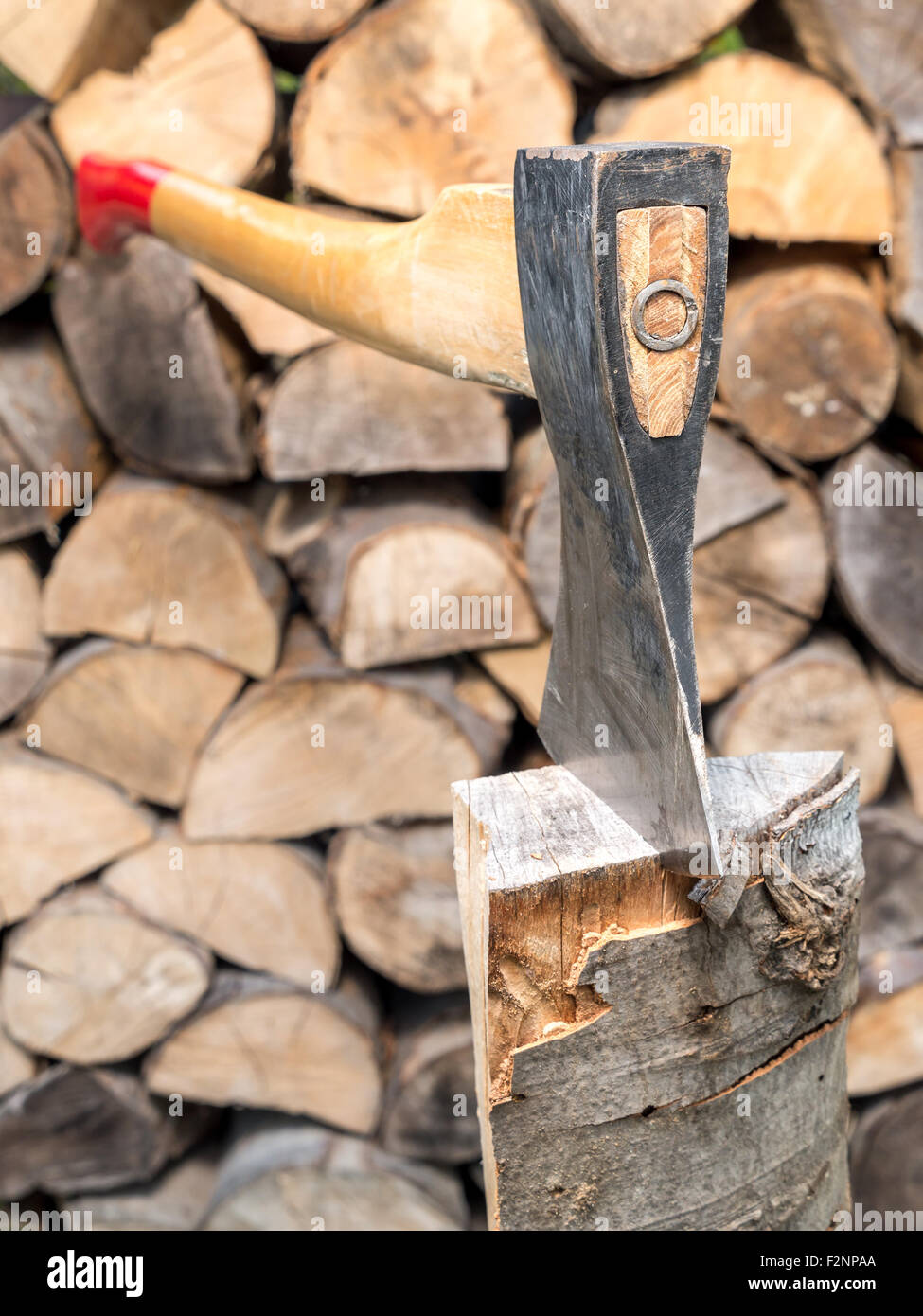 Chopping block with axe driven into log Stock Photo