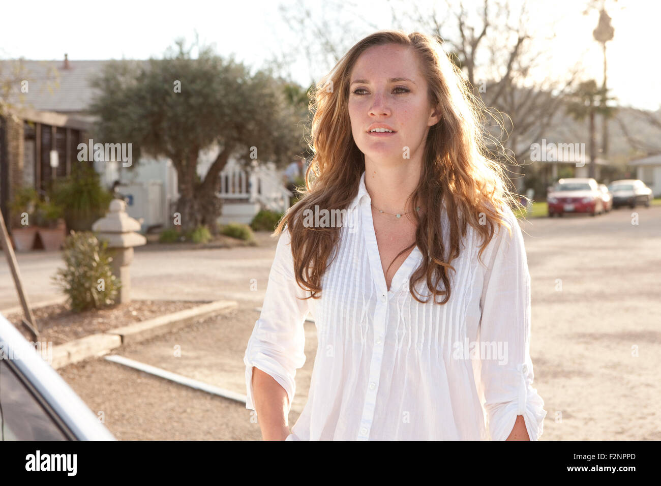 Woman standing in parking lot Stock Photo
