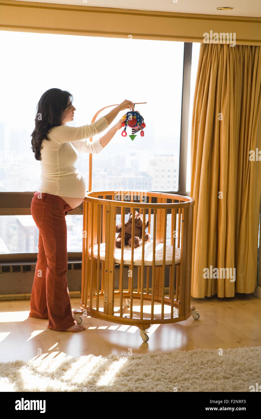 Pregnant woman decorating nursery Stock Photo Alamy