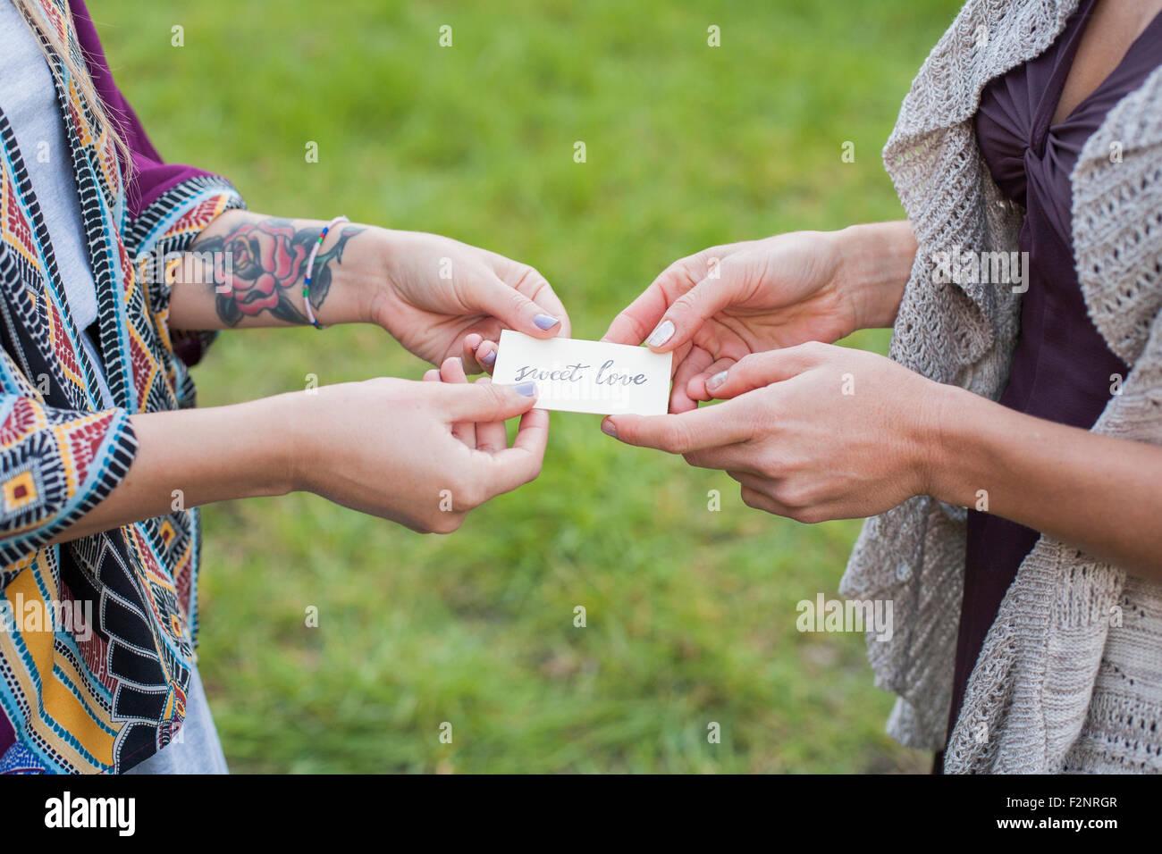 Close up of friends holding sweet love card Stock Photo