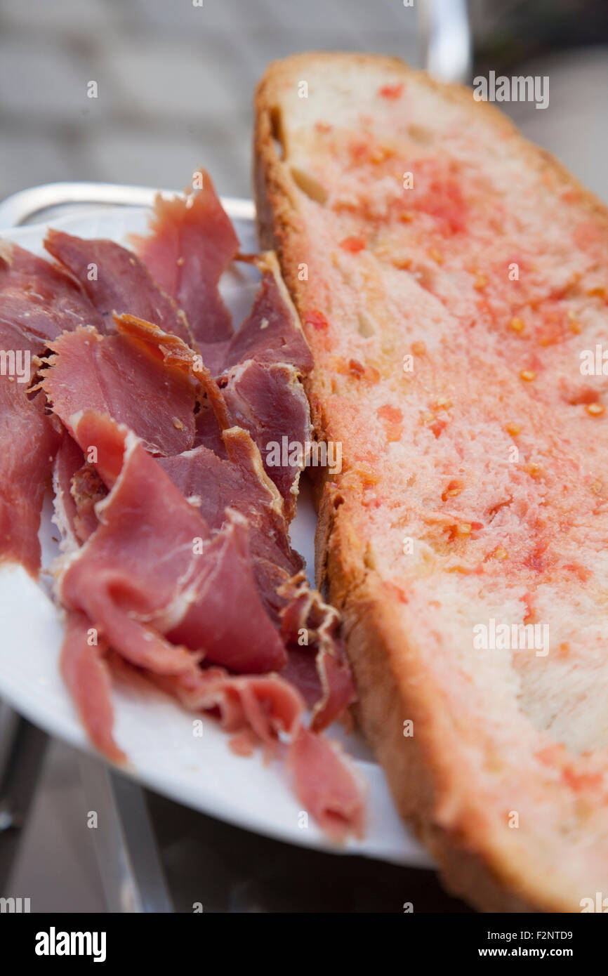 Spanish ham (jamón serraño) served with traditional Catalan 'Pa amb tomàquet' (Bread with tomato) Stock Photo