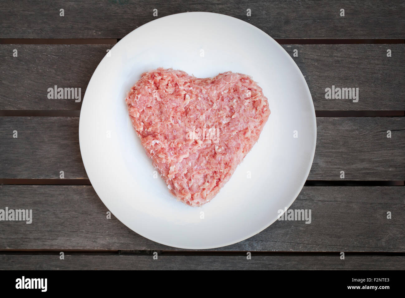 Heart-shaped raw minced meat Stock Photo