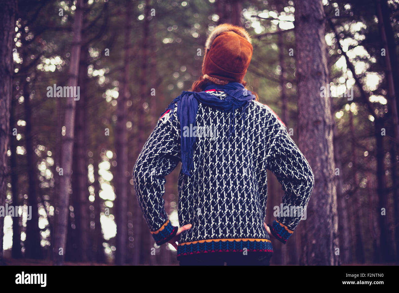 A young woman is standing in a forest Stock Photo - Alamy