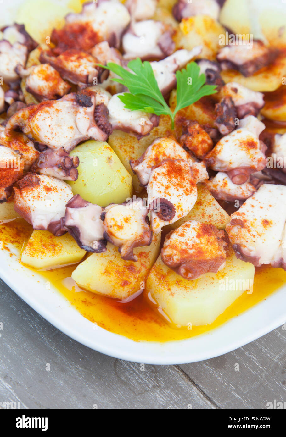 Polbo a Feira (Fair style octopus), a traditional Spanish Galician dish prepared with potatoes (cachelos), coarse salt, paprika Stock Photo