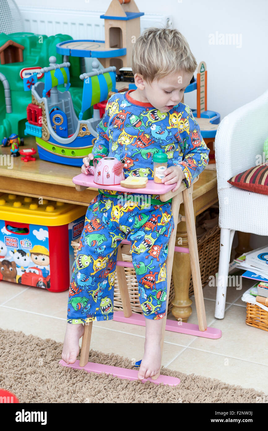 child stuck in toy high chair,exploration,tight fit,chair, high, eating, toddler, child, cute, human, messy, baby, fun, boy, sit Stock Photo