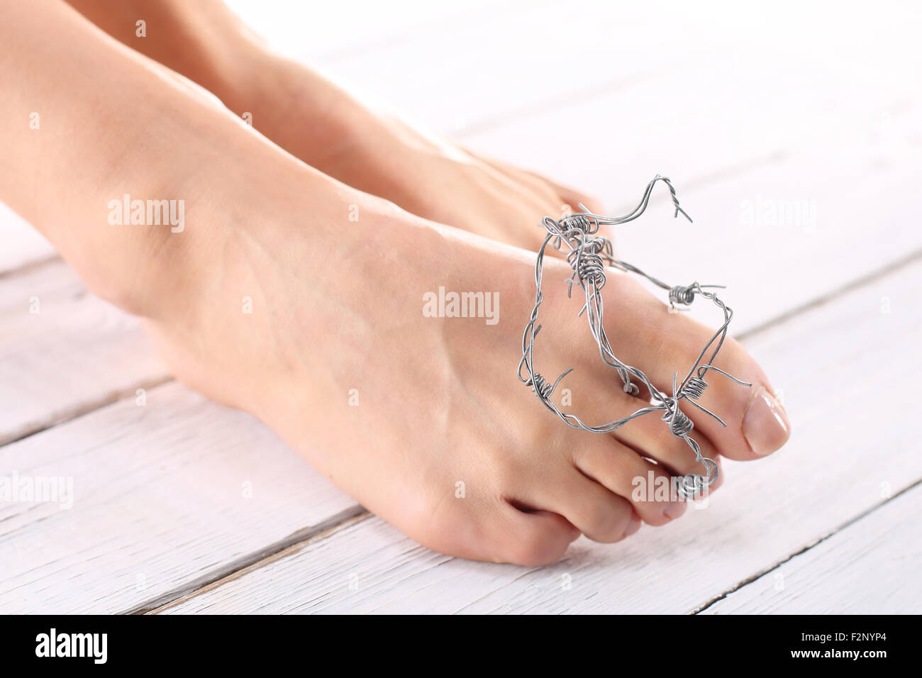 The rate of women wrapped in barbed wire, symbol of the pain of injury Stock Photo