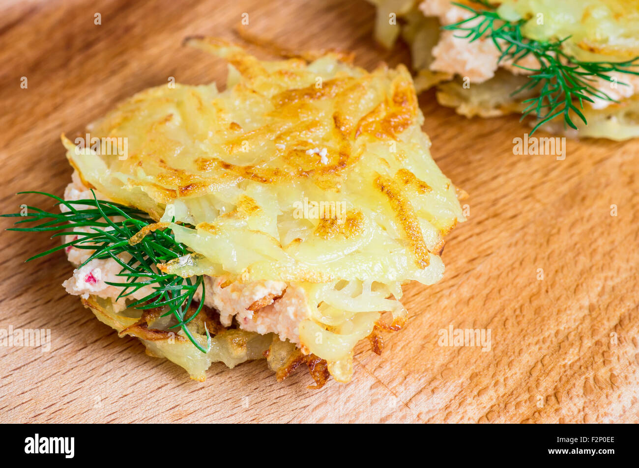 Tasty tapas of grated potatoes with a sauce of mascarpone cheese and chilli pepper Stock Photo