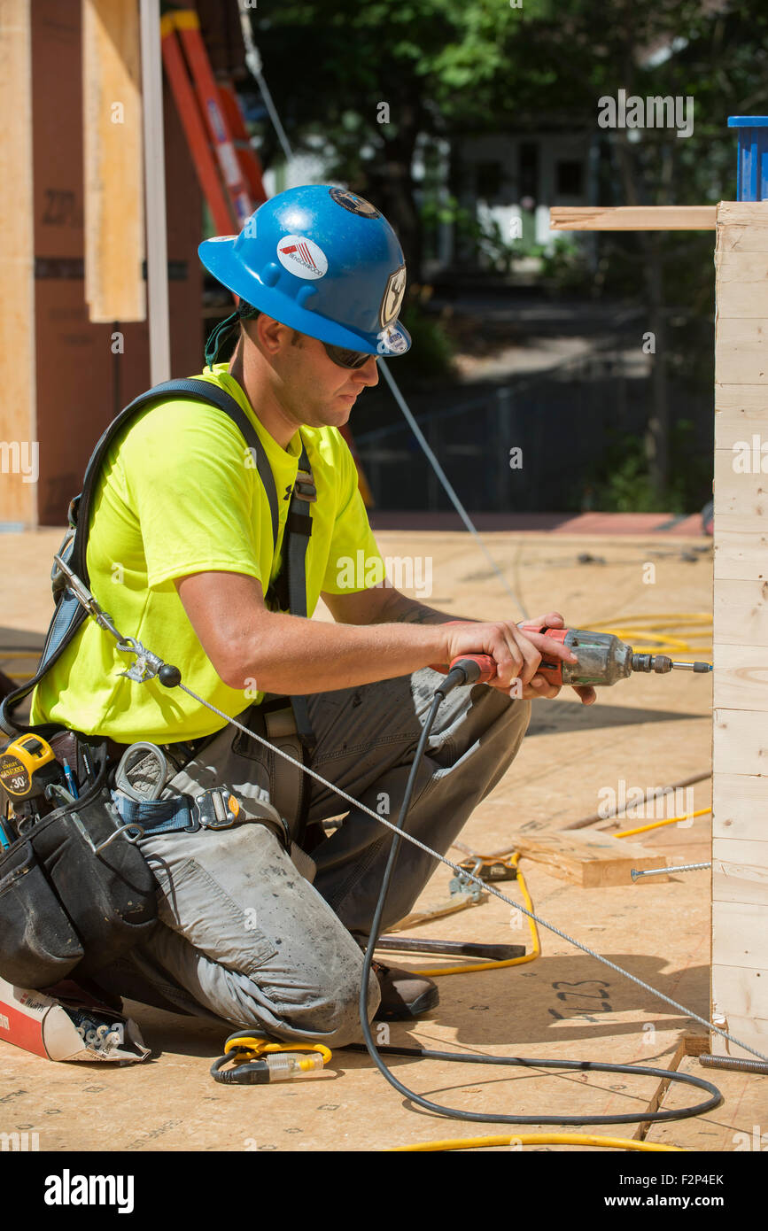 Construction workers uses electric drill to drive screw Stock Photo Alamy