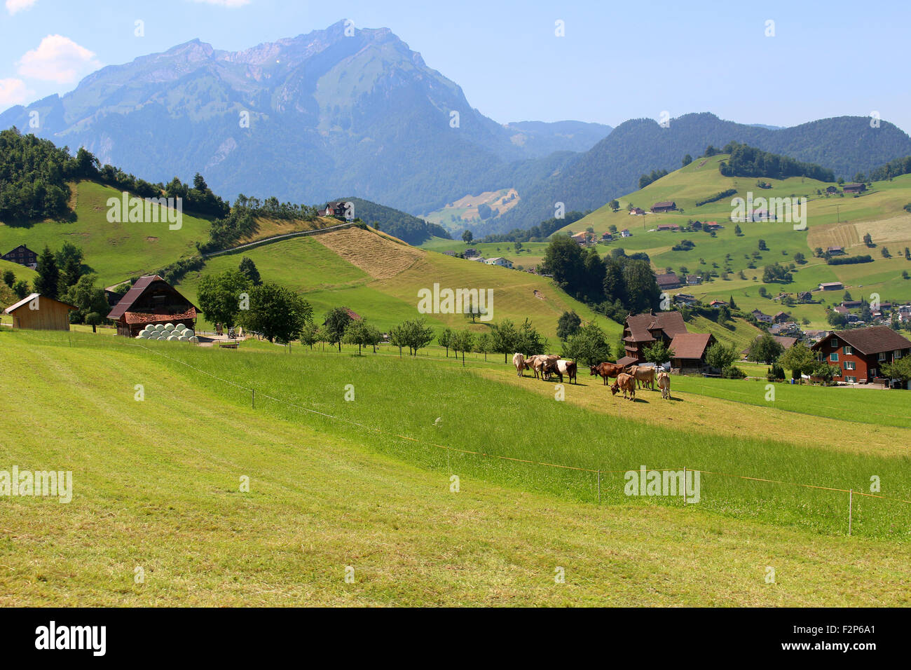 The Alps mountains in Switzerland on Mount Stastenhorn near Lucerne showing town and green pasture valley Stock Photo