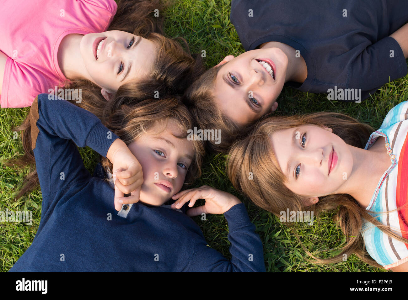 Group children laying on grass hi-res stock photography and images - Alamy