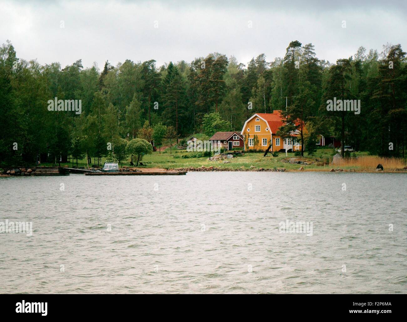 Helsinki, Finland. House and boat landing in coastal woodland on south coast of Finland east of Helsinki Stock Photo