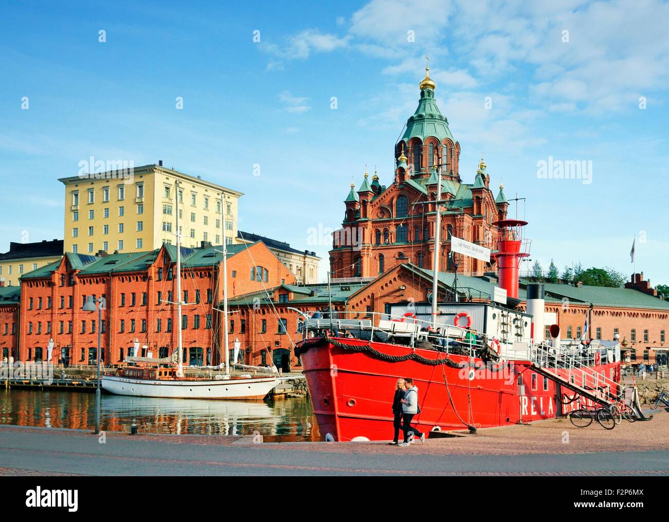 Helsinki, Finland. The Russian Orthodox Uspenski Cathedral rises behind retired light vessel Relandersgrund, now a restaurant Stock Photo