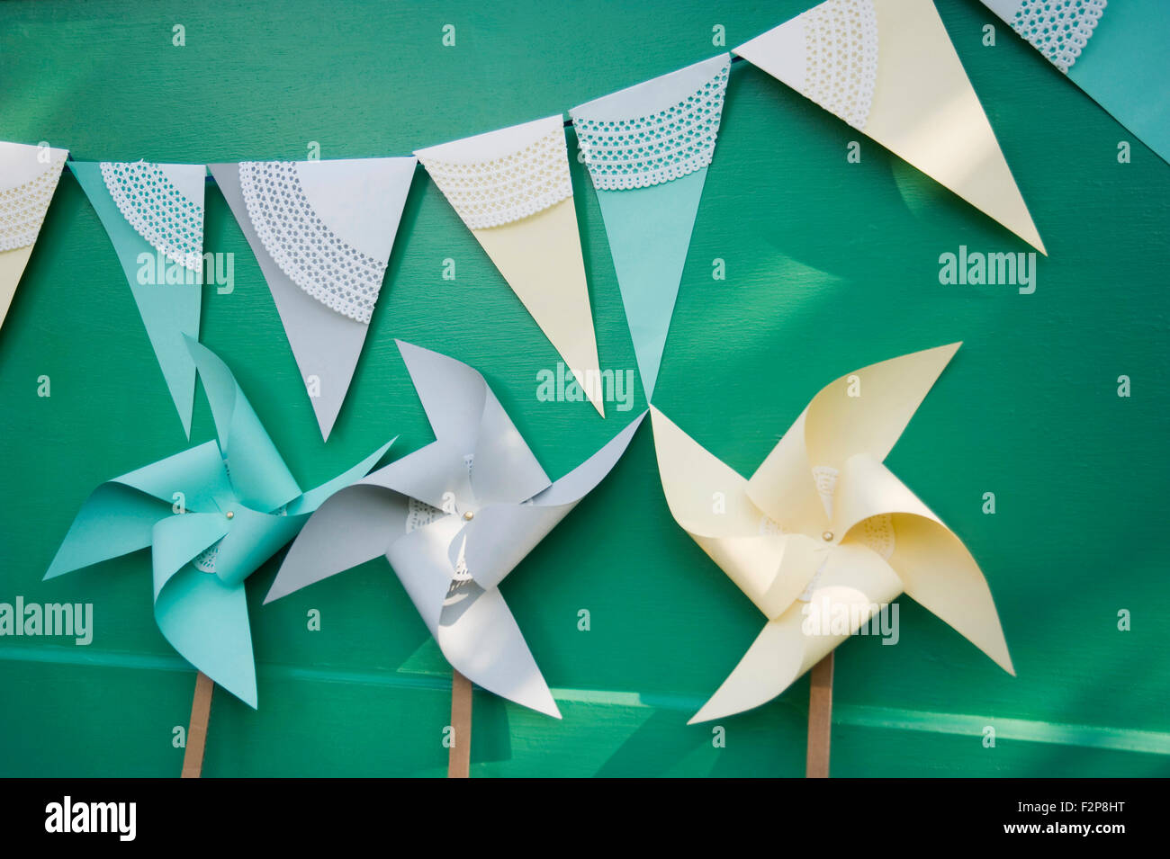 Self-made party decoration, paper windmills and bunting Stock Photo