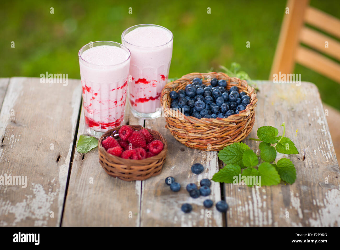 Raspberry milkshake in glasses, blueberries and raspberries Stock Photo