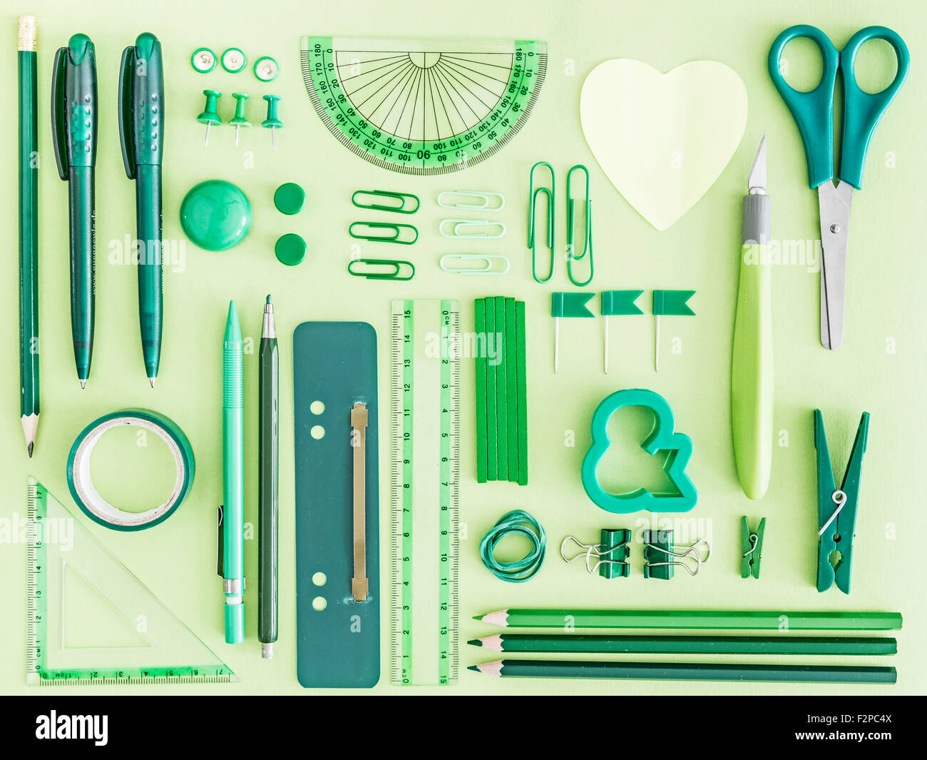 Green office supplies on green background Stock Photo Alamy