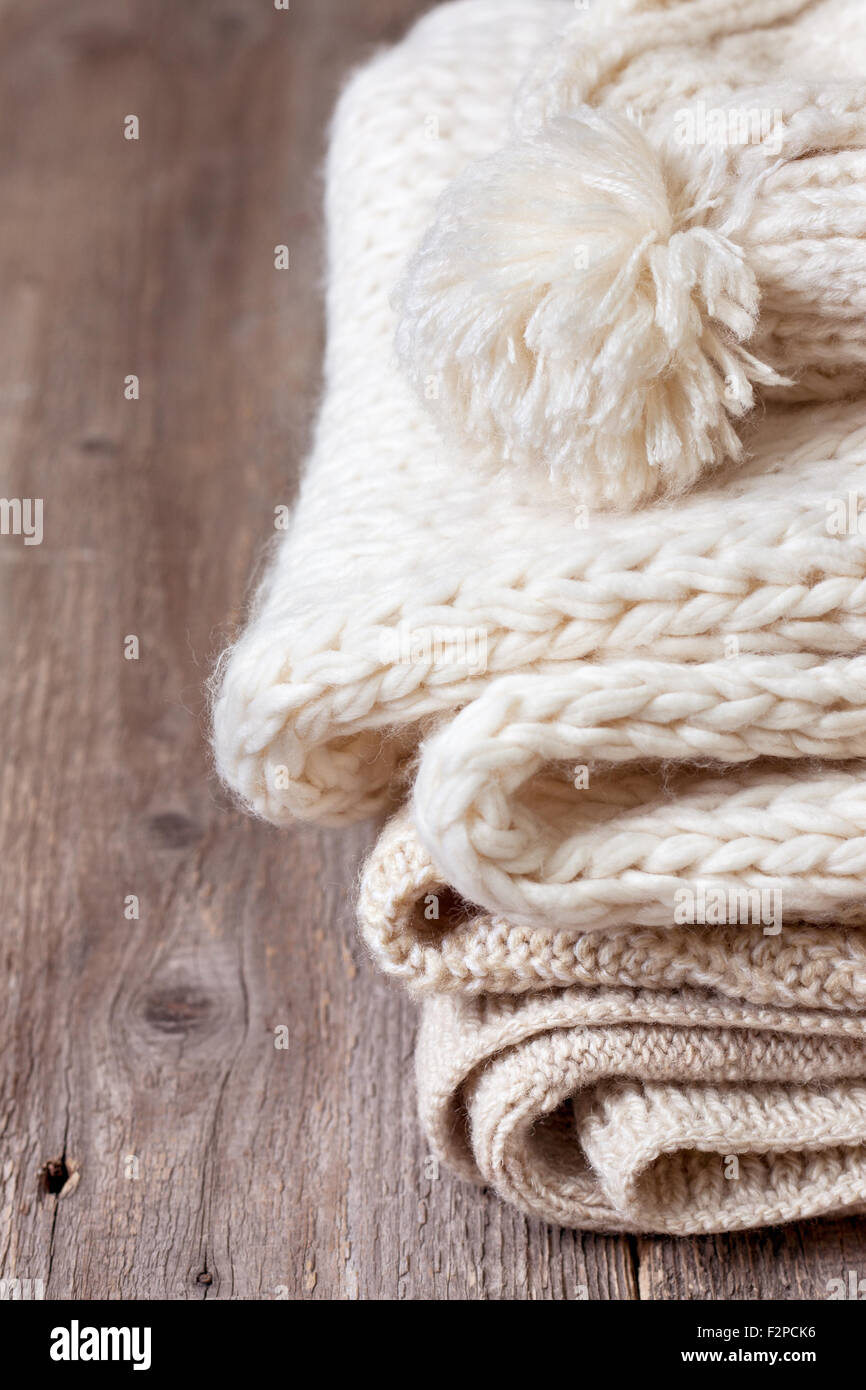 stack of warm clothes on old wooden background Stock Photo