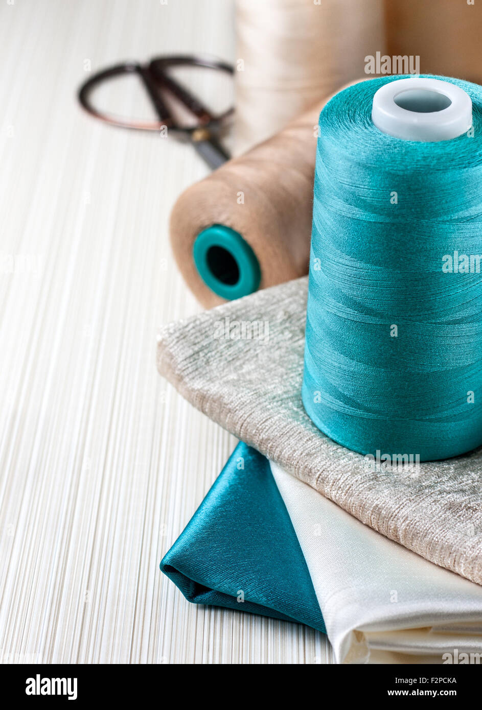 Sewing kit - spool of thread and different of multi-colored fabric ...