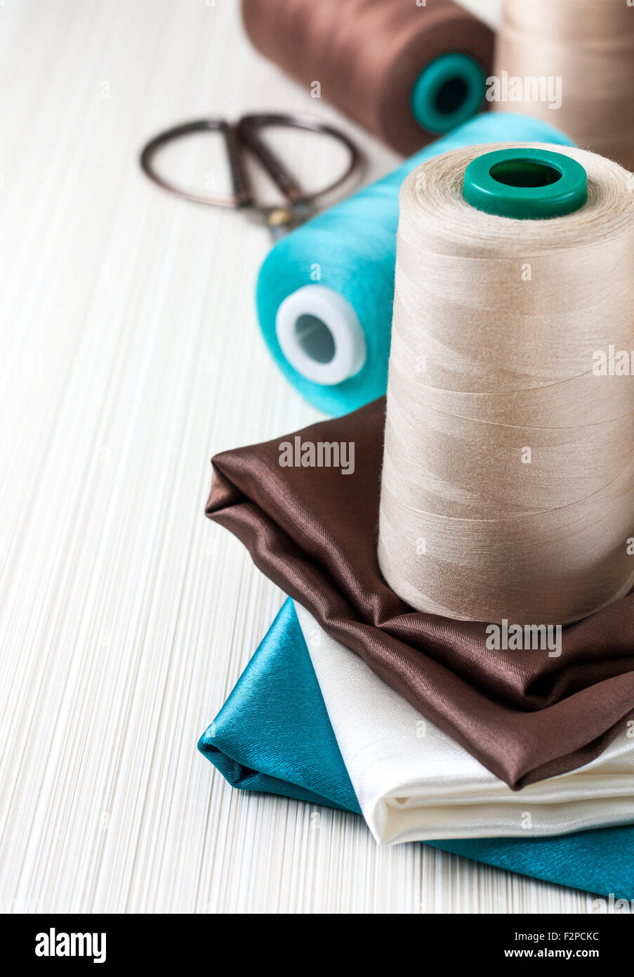 Sewing kit - spool of thread and different of multi-colored fabric ...