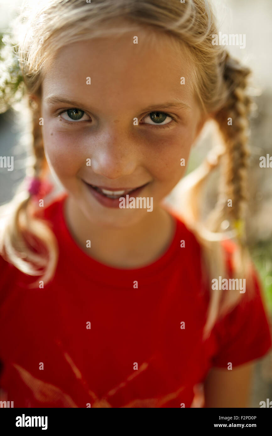 Portrait of smiling little girl with braids Stock Photo - Alamy