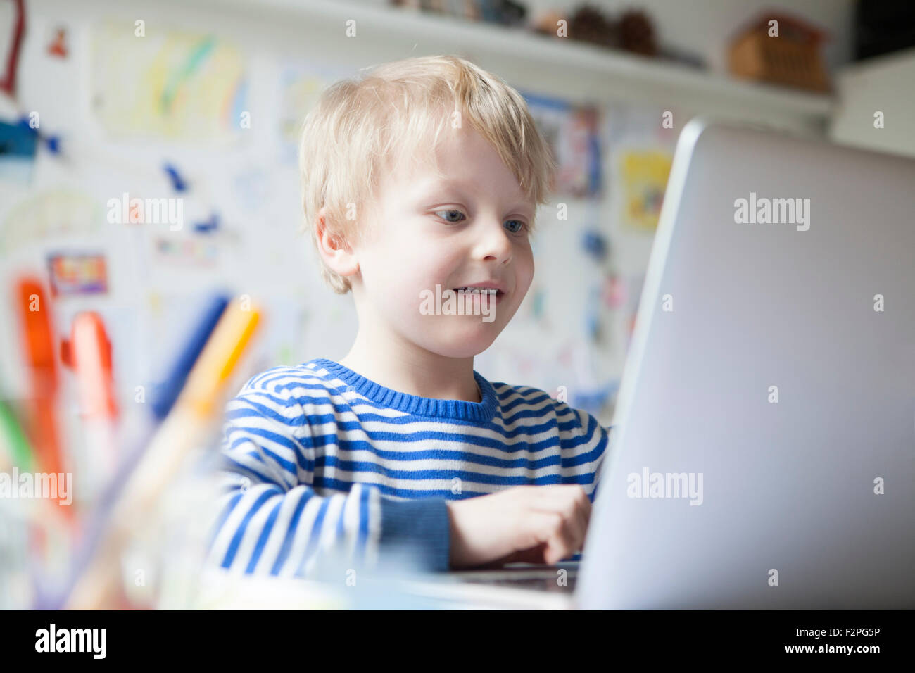 Portrait of little boy using laptop Stock Photo - Alamy