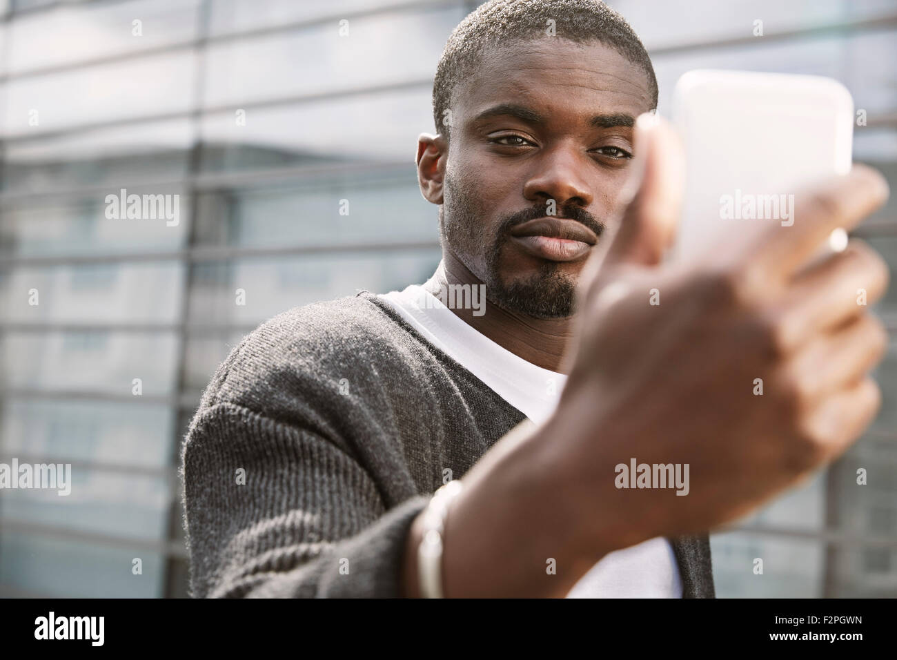 Young man taking a selfie outdoors Stock Photo