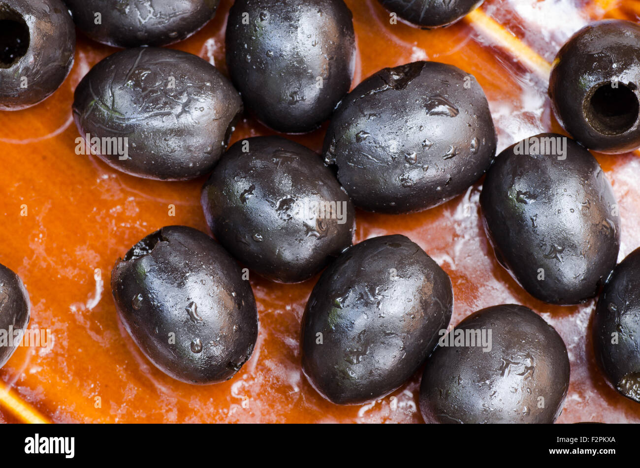 black olives on brown plate Stock Photo Alamy